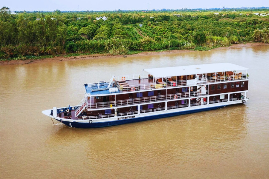 Aerial view of Mekong River Cruise sailing past lush greenery with Auasia Travel
